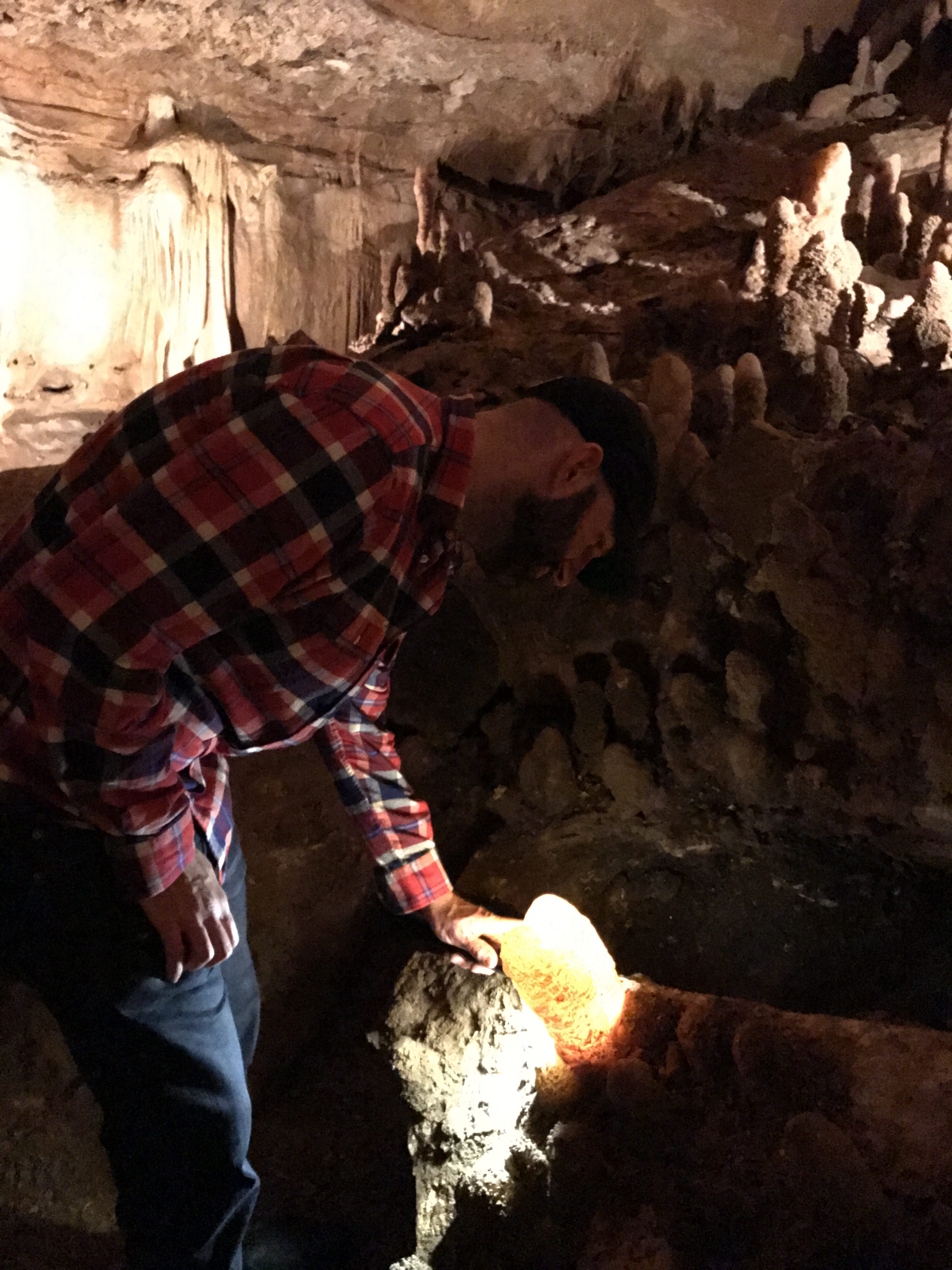 Using a flashlight to light up the cave